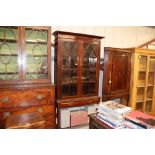 A glazed mahogany bookcase fitted two drawers rais
