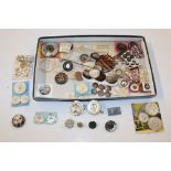 A box containing mother of pearl and other buttons