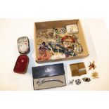 A box containing various costume jewellery, a comp