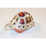 A Royal Crown Derby paperweight in the form of a t