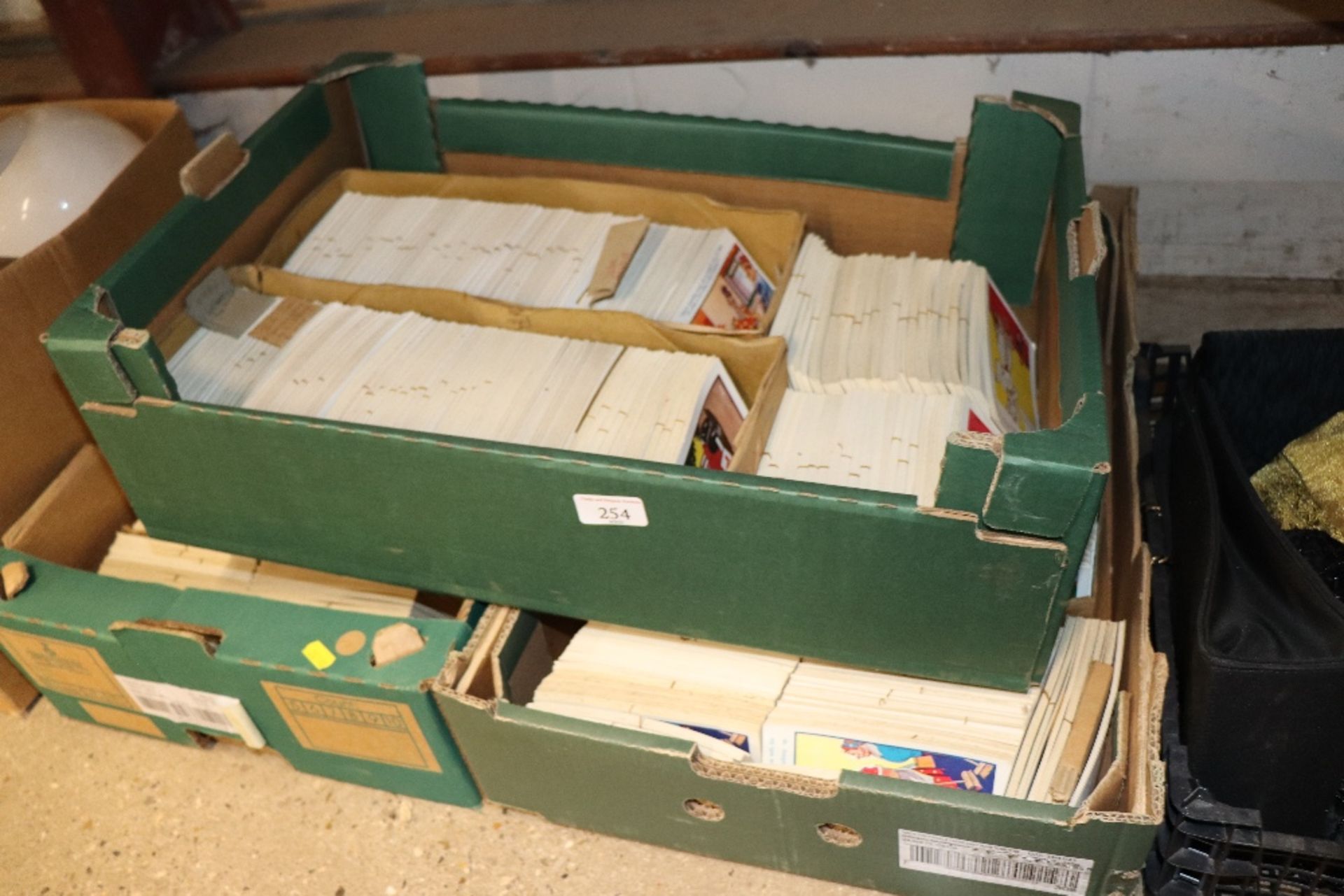 Three boxes containing various comic post-cards