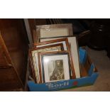 A box containing various pictures and prints