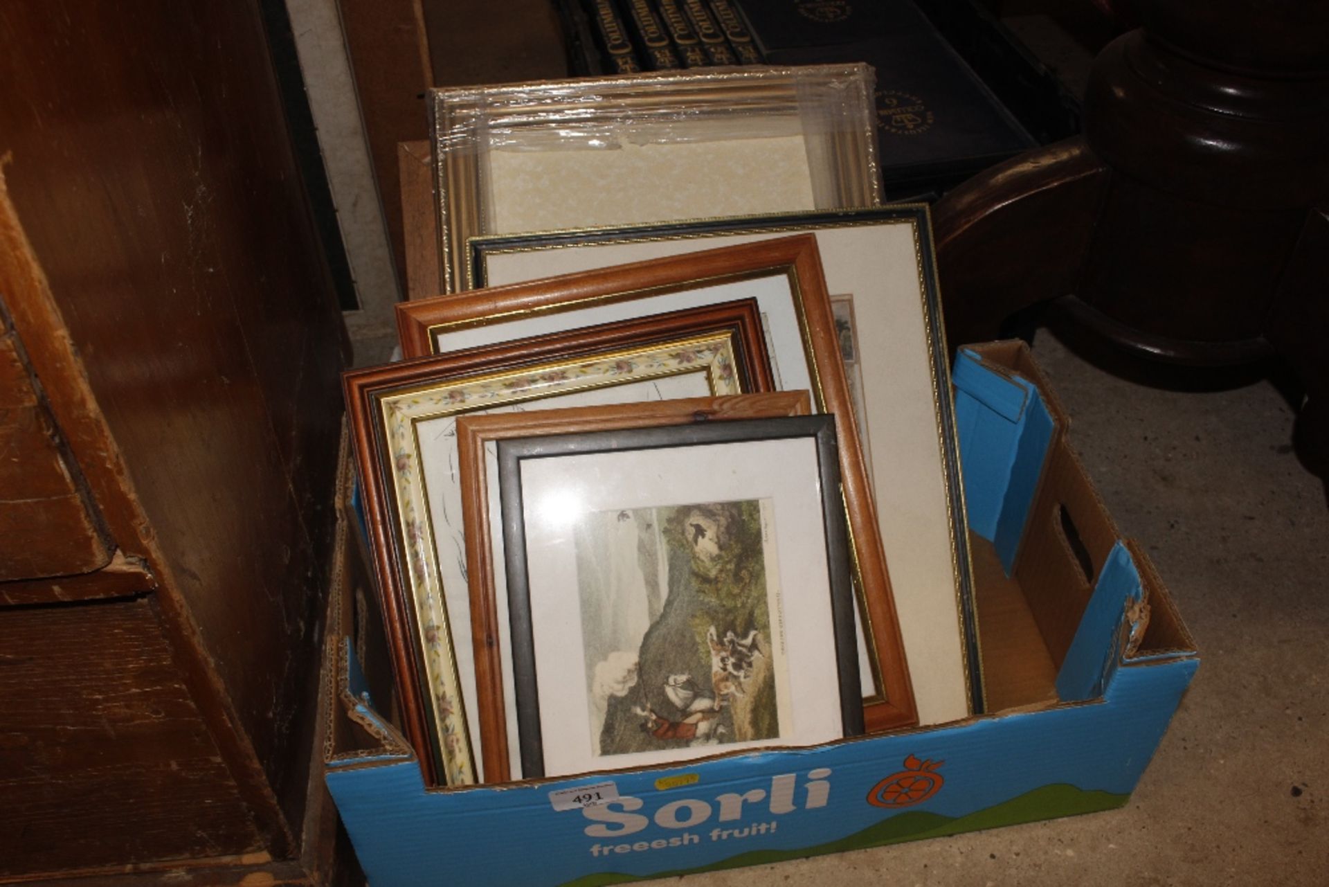 A box containing various pictures and prints