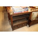 An oak bookcase raised on cupboard base