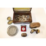 A box containing opera glasses, coinage, costume j