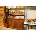 An oak mirrored back sideboard fitted two drawers