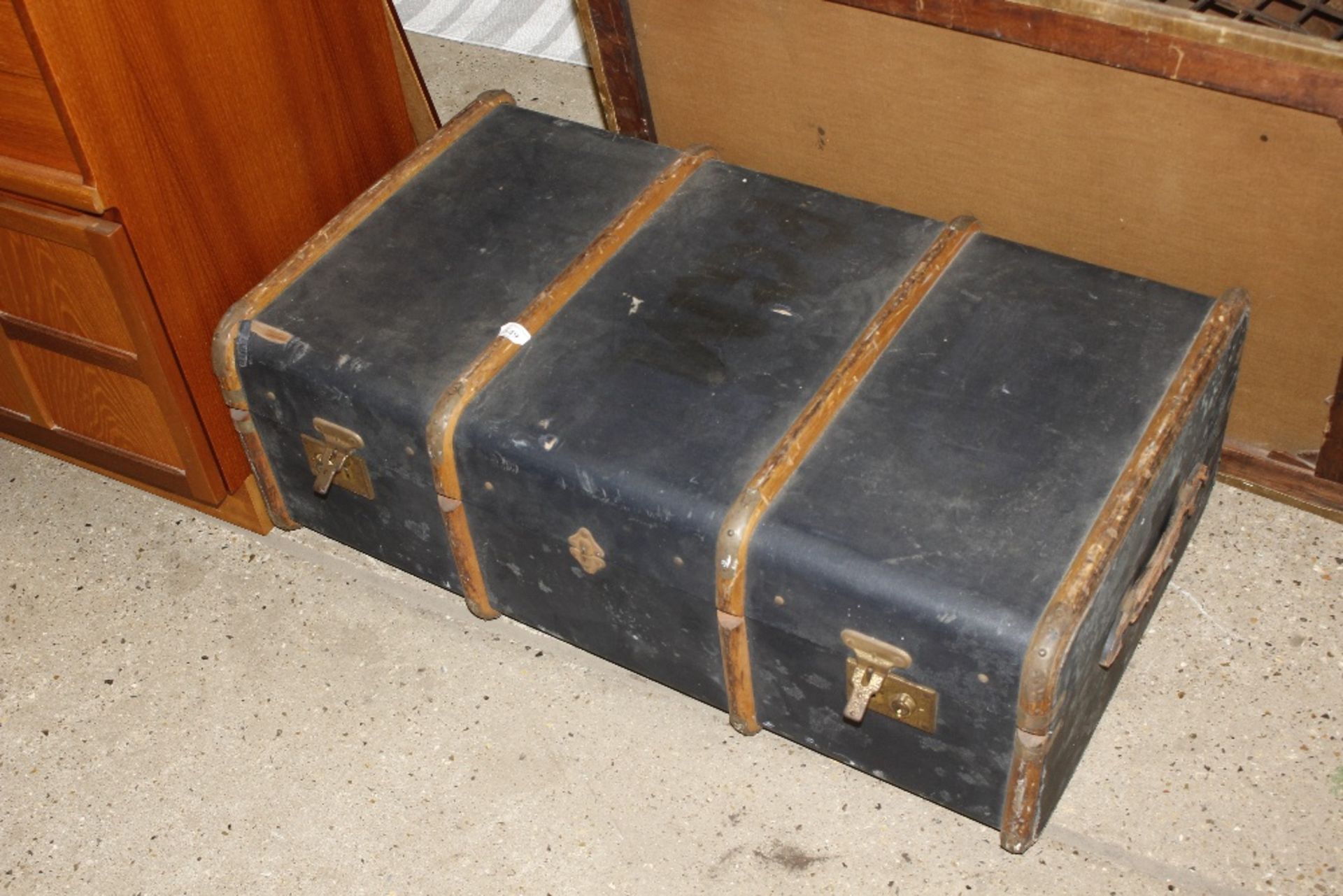 A wooden and metal bound travelling trunk