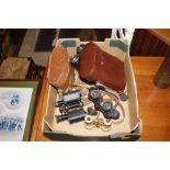 A box of various binoculars to include a Zeiss Pri