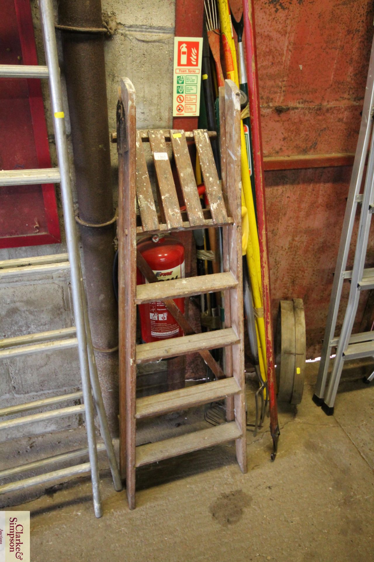 A wooden folding step ladder