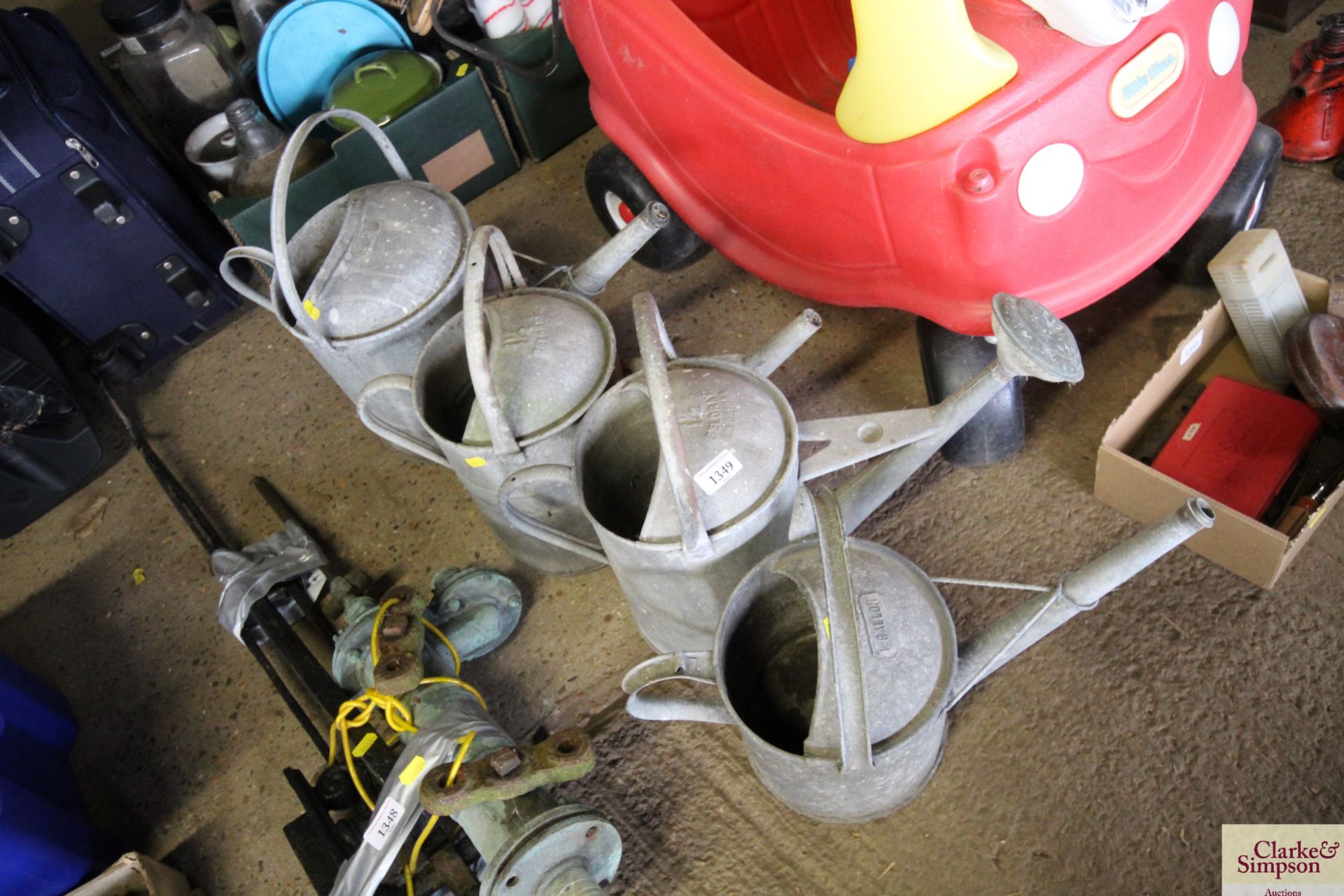 Four various sized watering cans measuring between