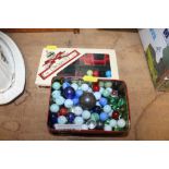 A tin of marbles and "House of Marbles" croquet