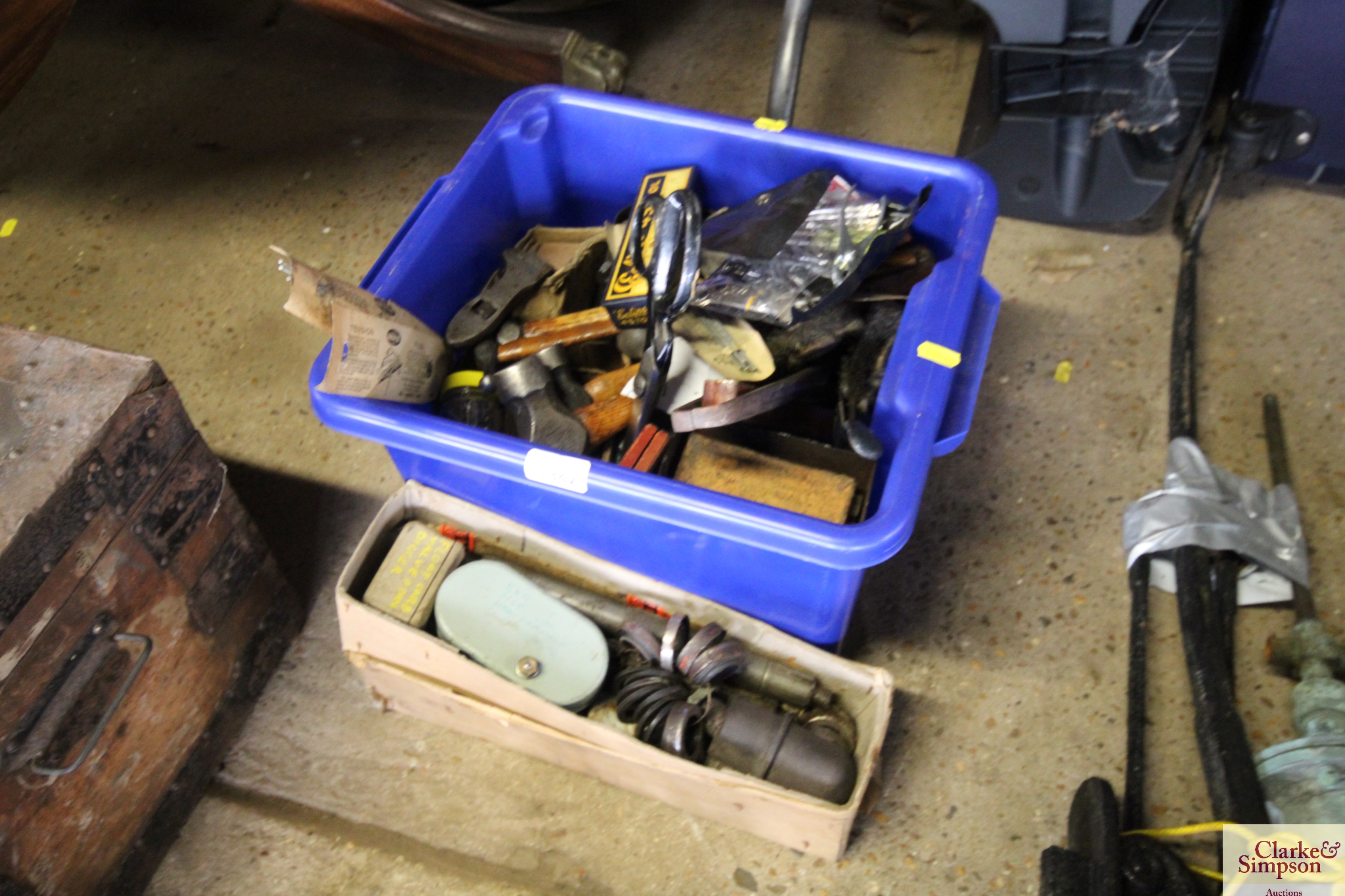 A plastic crate containing various hand tools to i