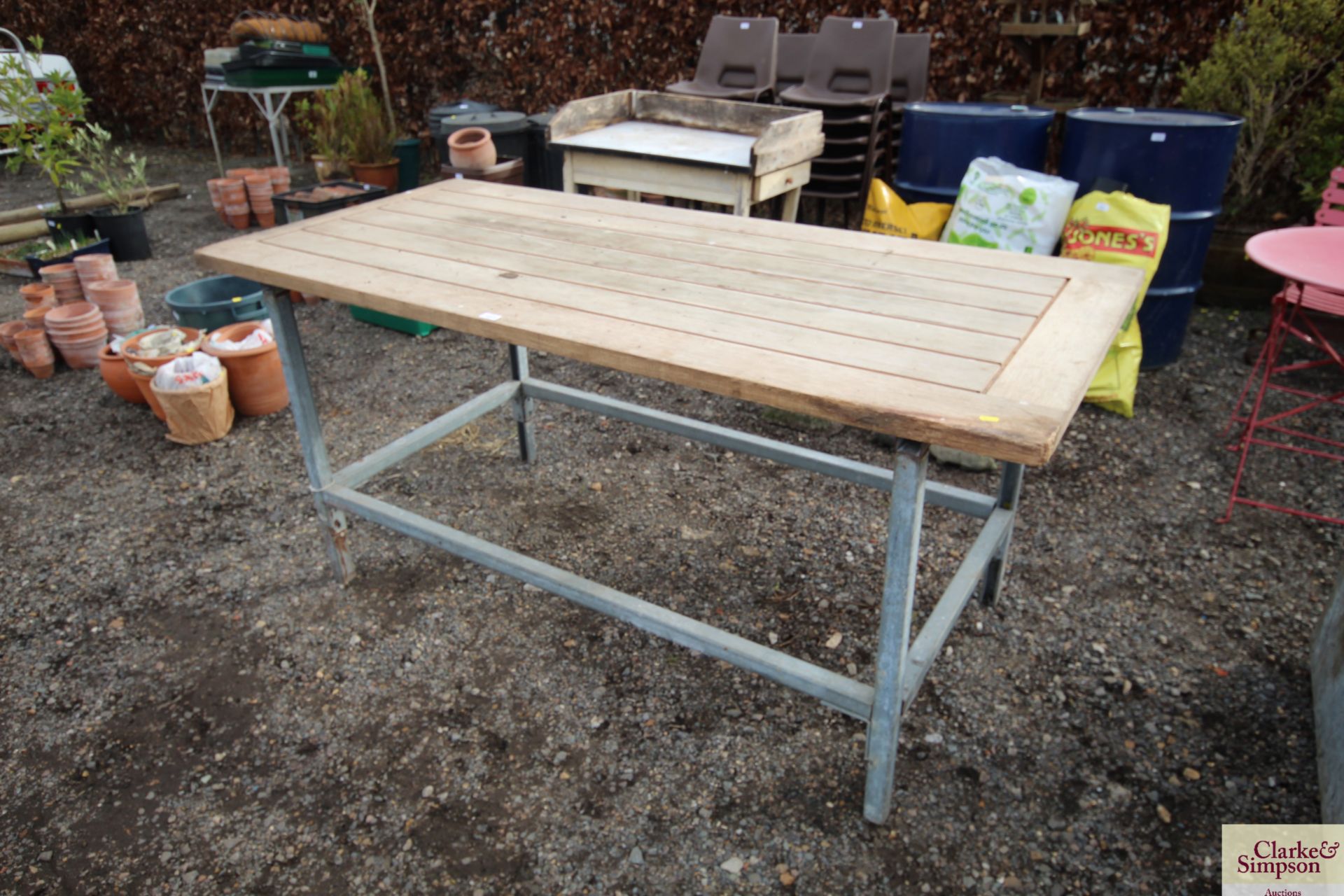 A galvanised base and wooden topped work table