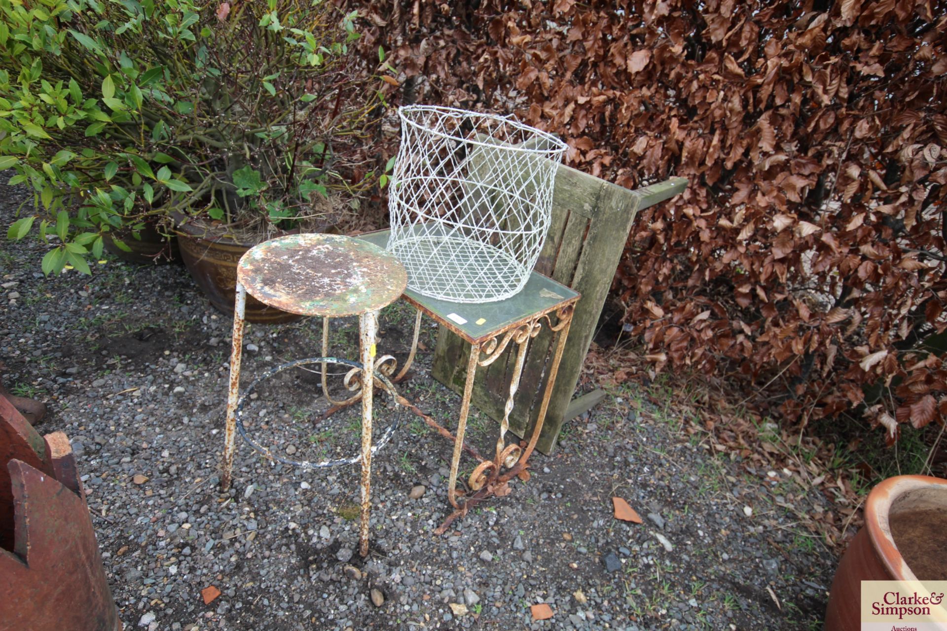 A small wrought iron glass topped table; a small w