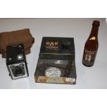 A Kodak box camera; a Adnams Southwold beer bottle