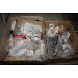 Two boxes containing various porcelain doll parts,