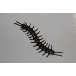 A bronzed model of a centipede