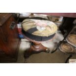 A Victorian piano stool with embroidered upholster