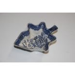 A blue and white willow pattern leaf shaped pickle