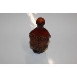 An amber coloured snuff bottle