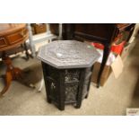An octagonal carved side table