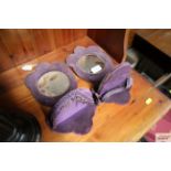 A pair of purple velvet upholstered mirrors