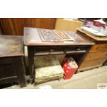 A pine side table fitted two drawers, raised on tu