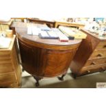 A Victorian mahogany bow front cupboard raised on