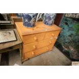 An orange painted pine chest fitted two short over