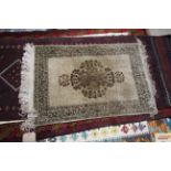 An approx. 3'2" x 1'11" Eastern pattern rug