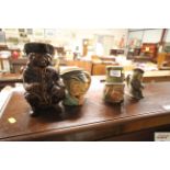 A brown glazed Toby jug and three other character