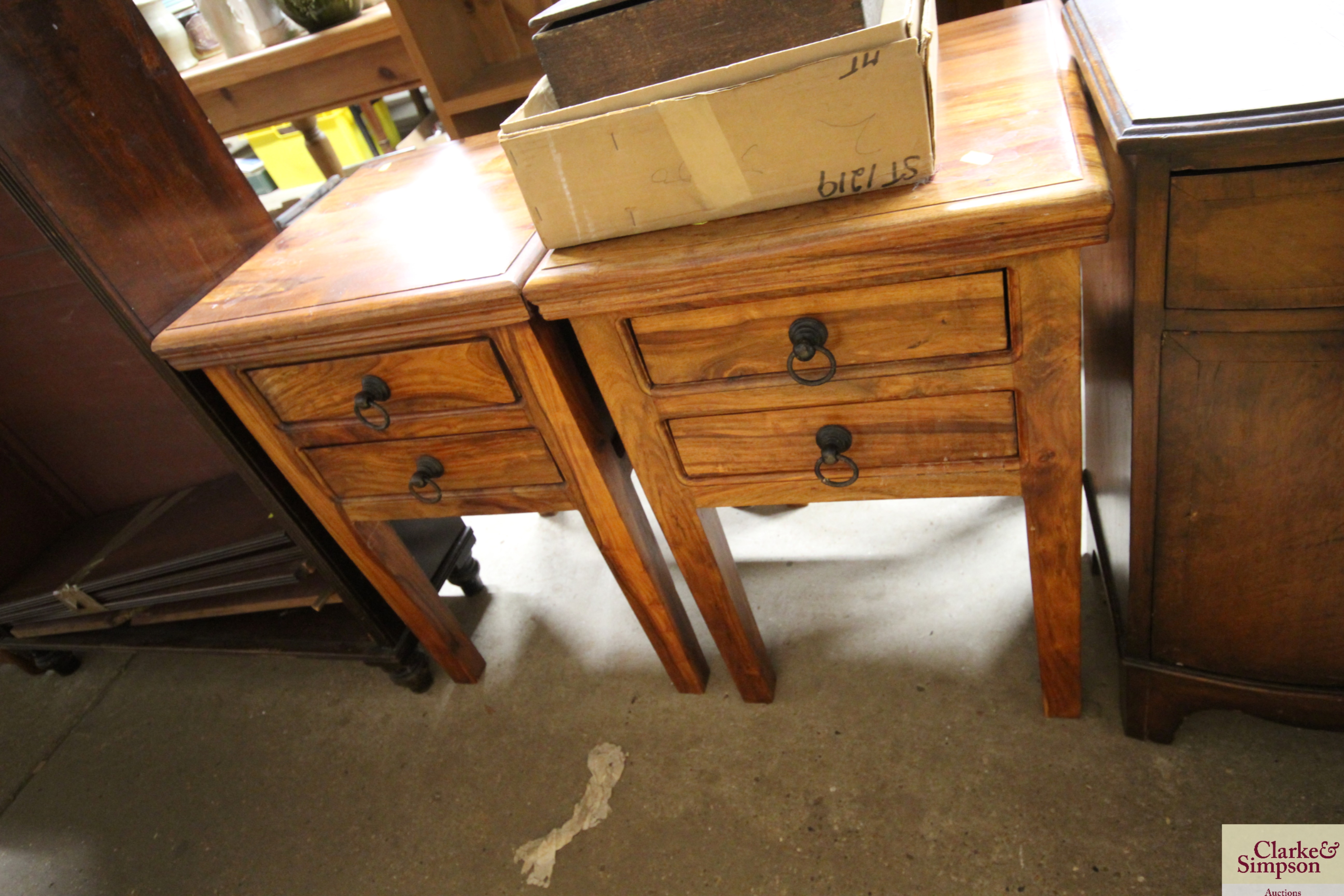 A pair of hardwood bedside tables fitted two drawe