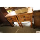 A pair of hardwood bedside tables fitted two drawe