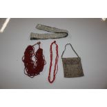 A coral necklace; a beadwork purse; and a belt