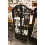 A cast iron gated garden mirror