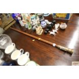 A walking stick with telescope/compass handle