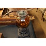 A Victorian oil lamp with cast iron base and amber