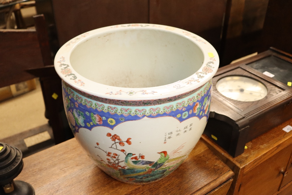 A large Chinese garden bowl with floral and bird d