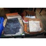 Two boxes containing various fabrics and linen