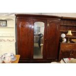 A Victorian mahogany mirrored door triple wardrobe