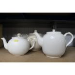 Three white glazed tea pots