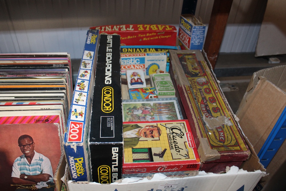 A box of various board games and puzzles