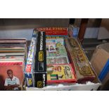 A box of various board games and puzzles