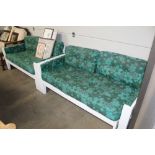 A pair of white framed sofa beds