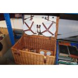 A wicker picnic basket and contents