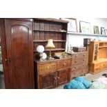 A stained pine dresser, base fitted cupboard with