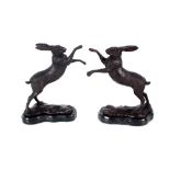 A pair of bronzed boxing hares, 29cm high