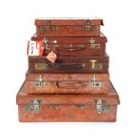 Five various leather suitcases