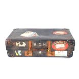 A Revelation suitcase bearing various labels inclu