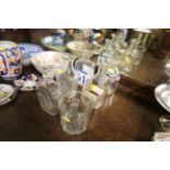 Six vintage spirit bottles and a glass wine cooler